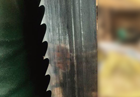 What is the role of the woodworking band saw blade roller bending force?